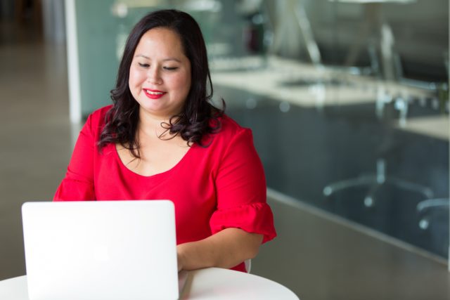 Woman working on laptop.